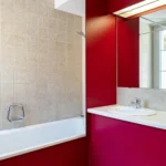 Hotelzimmer im Hotel Bad Eptingen mit roter Akzentwand und Bad